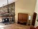 Living room with decorative stone fireplace, ceiling fan, and light colored hardwood floors at 103 Old Mill Pond Rd, Palm Harbor, FL 34683
