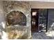 Stone outdoor fireplace is featured on the patio overlooking the home's interior with hardwood floors at 103 Old Mill Pond Rd, Palm Harbor, FL 34683