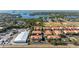 Aerial view of a townhouse community near green space and waterfront at 1264 Riserva Ln, Palm Harbor, FL 34683
