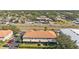 A beautiful aerial view of the property showcasing its tile roof and landscaping at 1264 Riserva Ln, Palm Harbor, FL 34683