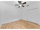Bedroom features hardwood floors, double closet doors, and a ceiling fan at 1264 Riserva Ln, Palm Harbor, FL 34683
