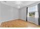 Bedroom with a ceiling fan, hardwood floors, and a large bright window at 1264 Riserva Ln, Palm Harbor, FL 34683