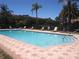 Community pool with lounge chairs on brick paver deck at 1264 Riserva Ln, Palm Harbor, FL 34683