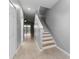 Hallway with tile flooring and a staircase leading upstairs with natural lighting at 1264 Riserva Ln, Palm Harbor, FL 34683