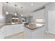 Bright kitchen with white cabinetry, granite countertops, and modern lighting fixtures at 1264 Riserva Ln, Palm Harbor, FL 34683