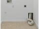 A utility room with tile flooring and hookups for a washer and dryer at 1264 Riserva Ln, Palm Harbor, FL 34683