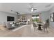 Comfortable living room with ample seating, large windows, and stylish decor, dining area to the right at 1264 Riserva Ln, Palm Harbor, FL 34683