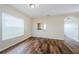 Bright living room boasts wood-look flooring and a pass-through to the kitchen at 1348 Impatiens Ct, Trinity, FL 34655
