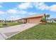 Charming single-story home featuring a well-manicured lawn and a two-car garage at 1809 Wolf Laurel Dr, Sun City Center, FL 33573