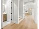 Hallway leading to an open kitchen with stainless steel appliances and hardwood floors at 3640 15Th N St, St Petersburg, FL 33704