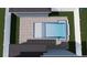 Aerial view of a backyard pool with a paver patio surrounded by a white fence at 3640 15Th N St, St Petersburg, FL 33704