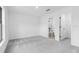 This spacious bedroom features a neutral carpet, a window, and an ensuite bathroom at 5402 Ojus St, North Port, FL 34286