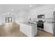 Spacious living room with an open concept to a modern kitchen, perfect for entertaining at 5402 Ojus St, North Port, FL 34286