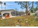 This backyard features a screened-in pool, a playhouse, and a grassy area, perfect for outdoor enjoyment at 1753 Lucas Dr, Clearwater, FL 33759