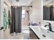 Neutral bathroom with single vanity, black hardware, and a shower over tub at 1753 Lucas Dr, Clearwater, FL 33759