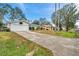This home boasts a well-maintained exterior, long driveway, and an attached garage at 1753 Lucas Dr, Clearwater, FL 33759