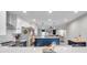 Modern kitchen boasts stainless steel appliances, white cabinets, and an island with a contrasting navy base at 1753 Lucas Dr, Clearwater, FL 33759