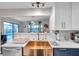 Updated kitchen with modern stainless steel appliances and a view to the pool outside at 1753 Lucas Dr, Clearwater, FL 33759