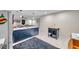 Modern kitchen featuring a large island, updated appliances, and access to the living room at 1753 Lucas Dr, Clearwater, FL 33759