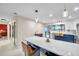 Modern kitchen featuring marble countertops, island with bar seating, and updated lighting at 1753 Lucas Dr, Clearwater, FL 33759