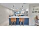Open kitchen featuring a large island with seating, stainless steel appliances, and modern pendant lighting at 1753 Lucas Dr, Clearwater, FL 33759