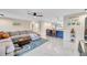 Spacious living room with updated lighting, neutral walls, and view to kitchen at 1753 Lucas Dr, Clearwater, FL 33759