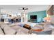 Open living room featuring a modern ceiling fan, neutral color palette and access to the kitchen at 1753 Lucas Dr, Clearwater, FL 33759