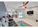 Open-concept living room with marble floors and access to the dining area and outdoor lanai at 1753 Lucas Dr, Clearwater, FL 33759