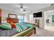 Comfortable bedroom with wood furniture, soft carpet, and a sliding glass door to the backyard at 1753 Lucas Dr, Clearwater, FL 33759