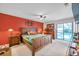 Main bedroom featuring wood furniture, soft carpet, and sliding glass doors leading to the pool area at 1753 Lucas Dr, Clearwater, FL 33759