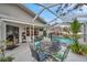 Spacious screened-in patio with outdoor seating and views of the pool area at 1753 Lucas Dr, Clearwater, FL 33759
