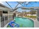 Backyard view of a screened pool with blue raft and safety fence at 1753 Lucas Dr, Clearwater, FL 33759