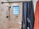 Modern shower featuring herringbone tile, window, and built-in niche at 1753 Lucas Dr, Clearwater, FL 33759