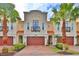 Charming two-story townhome featuring a private garage, balcony, and lush landscaping at 3222 W Empedrado St, Tampa, FL 33629