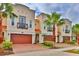 Elegant townhomes showcasing well-maintained landscaping, private garages, and balconies at 3222 W Empedrado St, Tampa, FL 33629