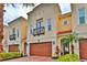 Elegant multi-story townhouse with a private balcony, beautiful landscaping, and a two-car garage at 3222 W Empedrado St, Tampa, FL 33629
