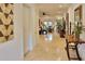 Inviting hallway with neutral tile flooring leading to the living and dining areas, creating an open, airy feel at 3222 W Empedrado St, Tampa, FL 33629