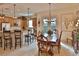 Open-concept kitchen with granite countertops, stainless steel appliances, and a dining area with a stylish chandelier at 3222 W Empedrado St, Tampa, FL 33629