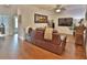 Cozy living room features hardwood flooring, a comfortable sofa, and a large screen TV, perfect for entertainment at 3222 W Empedrado St, Tampa, FL 33629
