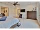 Airy main bedroom boasts neutral tones, a ceiling fan, and ample space for relaxation at 3222 W Empedrado St, Tampa, FL 33629