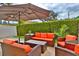 Cozy outdoor patio area featuring comfortable seating, a large umbrella, and well-maintained landscaping at 3222 W Empedrado St, Tampa, FL 33629