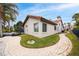 Well-maintained backyard with brick paver path, view of screened lanai, and tile roof at 5809 Cruiser Way, Tampa, FL 33615