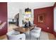 Elegant dining area with a modern chandelier, decorative mirror, and dark red wall at 5809 Cruiser Way, Tampa, FL 33615