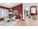 Elegant dining room featuring dark red accent wall and view of the fireplace in the living room at 5809 Cruiser Way, Tampa, FL 33615