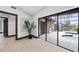Bright hallway with expansive sliding glass doors leading to a patio with pool and outdoor kitchen at 5809 Cruiser Way, Tampa, FL 33615