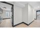 Bright hallway with sleek, dark accents, offering a modern look with ample natural light and stylish doors at 5809 Cruiser Way, Tampa, FL 33615