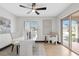 Bright home office with sleek white desk, modern decor, and a ceiling fan at 5809 Cruiser Way, Tampa, FL 33615