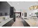 This modern kitchen features a large island with countertops, sleek black cabinetry, and stylish pendant lighting at 5809 Cruiser Way, Tampa, FL 33615