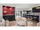 Stylish kitchen with a red accent wall, island seating, and a view of the backyard pool at 5809 Cruiser Way, Tampa, FL 33615