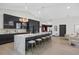 Open kitchen with an island, sleek appliances, and access to the dining area at 5809 Cruiser Way, Tampa, FL 33615